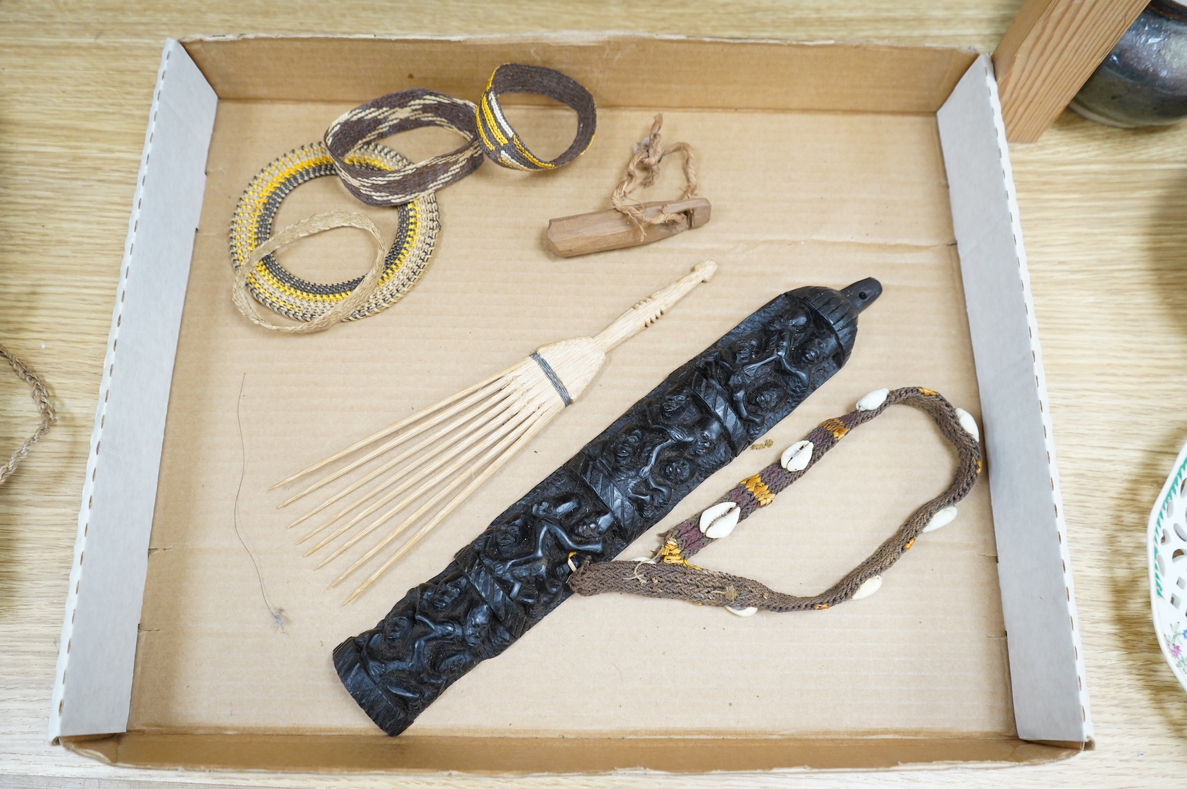 A collection of tribal carvings, straw bags, an abacus- 29cm wide and boomerang